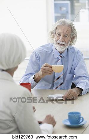 Senior Caucasian couple having coffee in cafe View Large Photo Image Stock Image - Senior Caucasian couple having coffee in cafe. Fotosearch