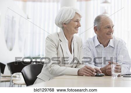 Senior Caucasian couple smiling in cafe View Large Photo Image Stock Photo - Senior Caucasian couple smiling in cafe. Fotosearch