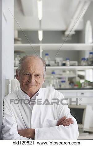 Stock Image - Senior Caucasian scientist smiling in lab. Fotosearch