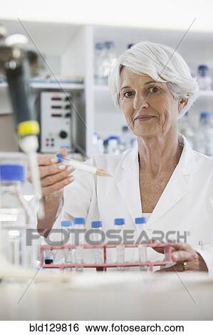 Senior Caucasian scientist testing samples in lab View Large Photo Image Stock Photograph - Senior Caucasian scientist testing samples in lab. Fotosearch