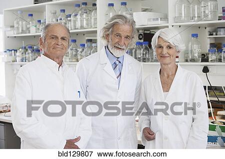 Stock Photo - Senior Caucasian scientists smiling in lab. Fotosearch