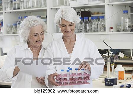 Stock Image - Senior Caucasian scientists working in lab. Fotosearch