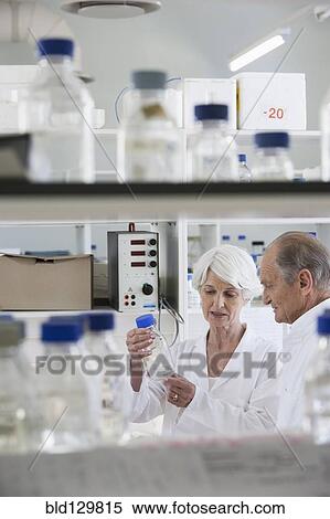 Stock Photography - Senior Caucasian scientists working in lab. Fotosearch