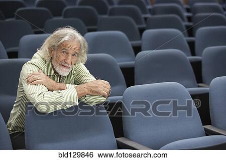 Stock Photograph - Senior Caucasian student sitting in classroom. Fotosearch