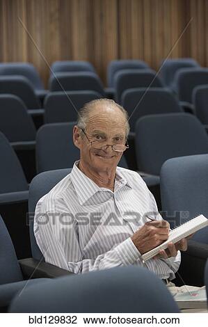 Senior Caucasian student working in classroom View Large Photo Image Stock Image - Senior Caucasian student working in classroom. Fotosearch
