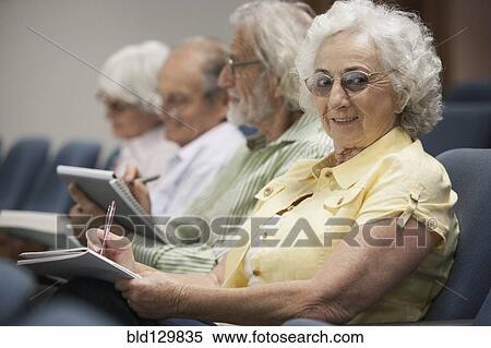 Stock Photography - Senior Caucasian students taking notes in classroom. Fotosearch