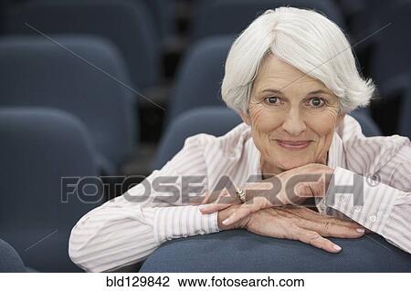 Senior Caucasian woman smiling in lecture hall View Large Photo Image Stock Image - Senior Caucasian woman smiling in lecture hall. Fotosearch