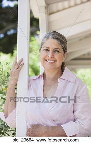Senior Caucasian woman standing on porch View Large Photo Image Picture - Senior Caucasian woman standing on porch. Fotosearch