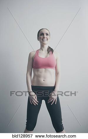 Stock Photo - Smiling Caucasian woman in sportswear. Fotosearch