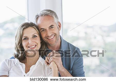 Stock Photograph - Smiling couple holding hands. Fotosearch