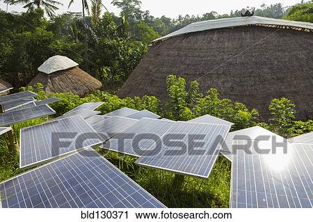 Solar panels among thatched roof buildings View Large Photo Image Stock Image - Solar panels among thatched roof buildings. Fotosearch