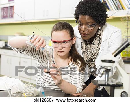 Stock Photo - Student and teacher working in chemistry lab. Fotosearch