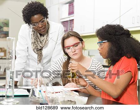 Stock Photo - Students and teacher working in chemistry lab. Fotosearch