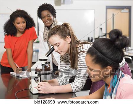 Stock Photo - Students and teacher working in chemistry lab. Fotosearch