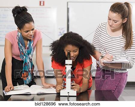 Stock Photograph - Students working together in chemistry lab. Fotosearch
