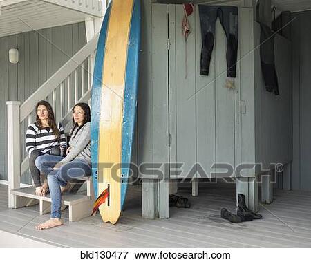 Surfers relaxing on patio View Large Photo Image Stock Photo - Surfers relaxing on patio. Fotosearch