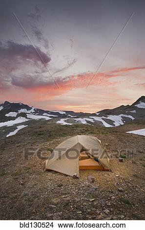 Picture - Tent at campsite in snowy mountain landscape. Fotosearch