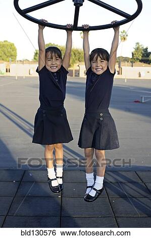 Twin girls playing on playground View Large Photo Image Stock Photograph - Twin girls playing on playground. Fotosearch