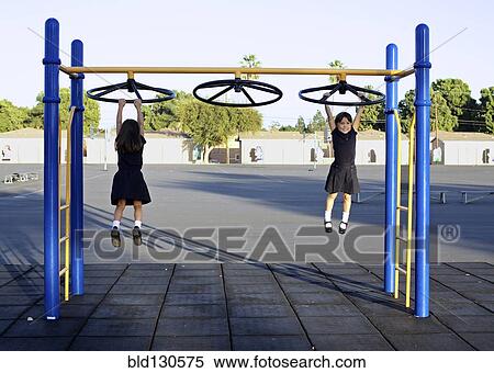 Twin girls playing on playground View Large Photo Image Stock Photography - Twin girls playing on playground. Fotosearch