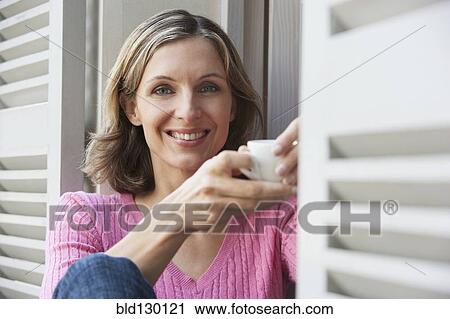 Woman having cup of coffee outdoors View Large Photo Image Stock Image - Woman having cup of coffee outdoors. Fotosearch