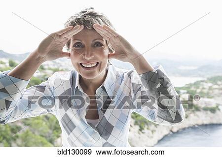 Stock Photo - Woman peering through window. Fotosearch