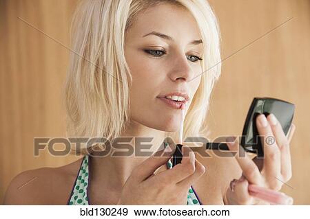 Woman putting on makeup View Large Photo Image Stock Photo - Woman putting on makeup. Fotosearch