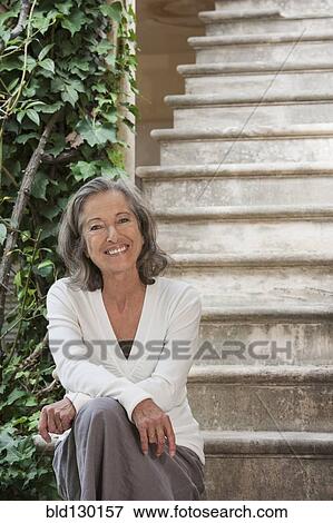 Woman sitting on front steps View Large Photo Image Stock Photo - Woman sitting on front steps. Fotosearch