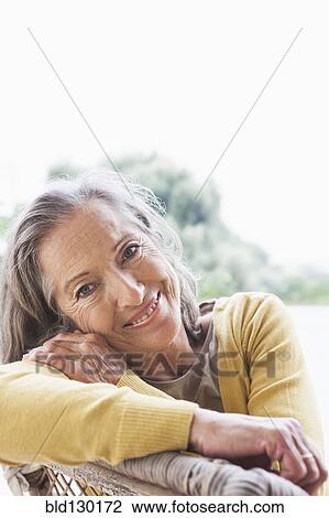 Stock Image - Woman smiling outdoors. Fotosearch