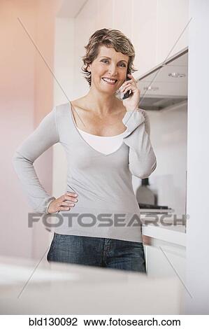 Woman talking on phone View Large Photo Image Stock Image - Woman talking on phone. Fotosearch