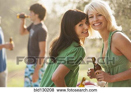 Women drinking beer outdoors View Large Photo Image Stock Photo - Women drinking beer outdoors. Fotosearch