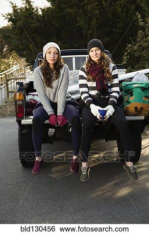 Women sitting together in truck bed View Large Photo Image Stock Photograph - Women sitting together in truck bed. Fotosearch