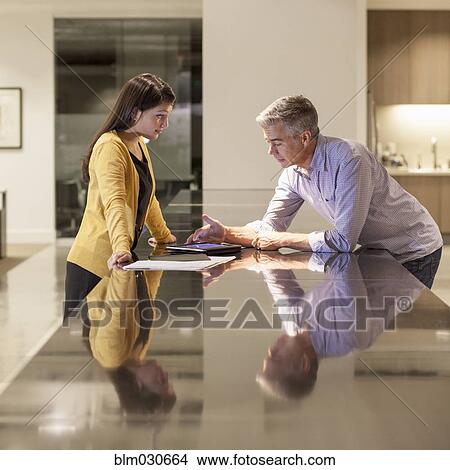 Business people using digital tablet in office View Large Photo Image Picture - Business people using digital tablet in office. Fotosearch