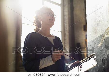 Caucasian artist painting in studio View Large Photo Image Picture - Caucasian artist painting in studio. Fotosearch