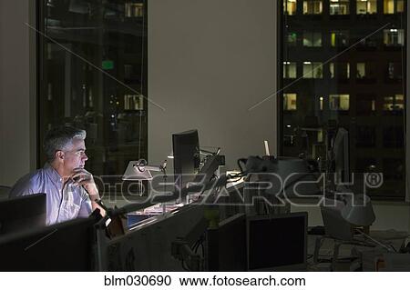 Caucasian businessman working late in office View Large Photo Image Stock Image - Caucasian businessman working late in office. Fotosearch