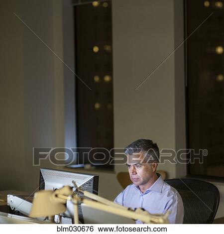 Caucasian businessman working late in office View Large Photo Image Stock Photograph - Caucasian businessman working late in office. Fotosearch