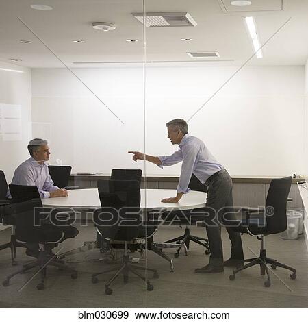 Stock Photo - Caucasian businessmen having meeting in office. Fotosearch