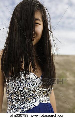 Chinese teenage girl wearing gown in rural field View Large Photo Image Stock Photo - Chinese teenage girl wearing gown in rural field. Fotosearch