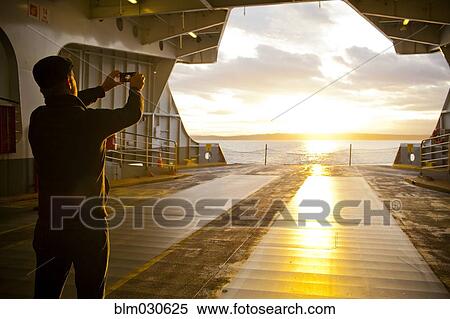 Man taking picture out ferry gate View Large Photo Image Stock Photography - Man taking picture out ferry gate. Fotosearch