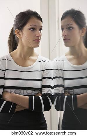 Mixed race businesswoman admiring herself in mirror View Large Photo Image Stock Image - Mixed race businesswoman admiring herself in mirror. Fotosearch