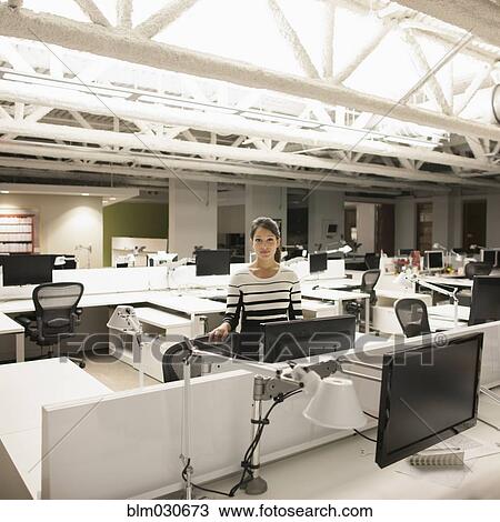 Stock Image - Mixed race businesswoman working late in office. Fotosearch