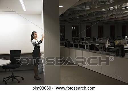 Mixed race businesswoman working late in office View Large Photo Image Stock Photo - Mixed race businesswoman working late in office. Fotosearch