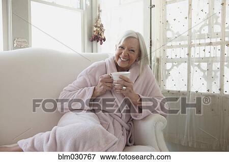 Senior Caucasian woman drinking coffee in bathrobe View Large Photo Image Stock Photo - Senior Caucasian woman drinking coffee in bathrobe. Fotosearch