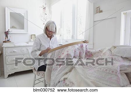 Senior Caucasian woman stitching blanket View Large Photo Image Stock Image - Senior Caucasian woman stitching blanket. Fotosearch
