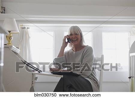 Stock Image - Senior Caucasian woman talking on telephone. Fotosearch
