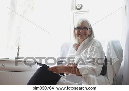 Picture - Senior Caucasian woman using digital tablet. Fotosearch
