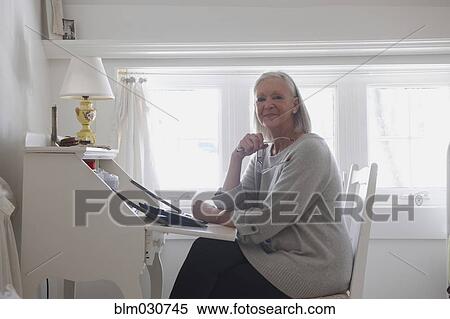Stock Photography - Senior Caucasian woman using laptop. Fotosearch