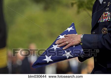 Picture - Soldier folding flag at military funeral. Fotosearch