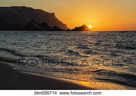 Picture - Sun setting over rocky coastline, Qalansyia, Socotra, Yemen. Fotosearch
