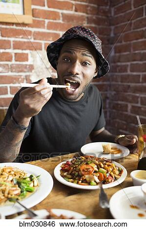 African American man eating at restaurant View Large Photo Image Stock Photograph - African American man eating at restaurant. Fotosearch