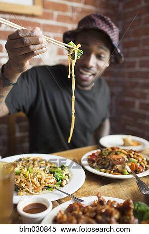 African American man eating at restaurant View Large Photo Image Stock Photography - African American man eating at restaurant. Fotosearch